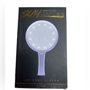 Impressions LED Cristal clear lighted hand mirror with a touch of a button
